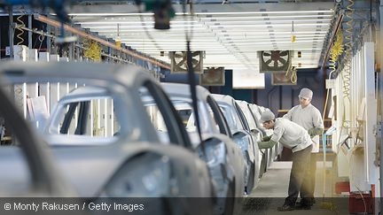 Two workers in a car factory