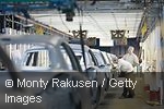 Two workers in a car factory
